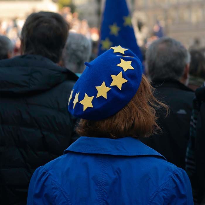 a woman wearing a beret with the eu stars on it